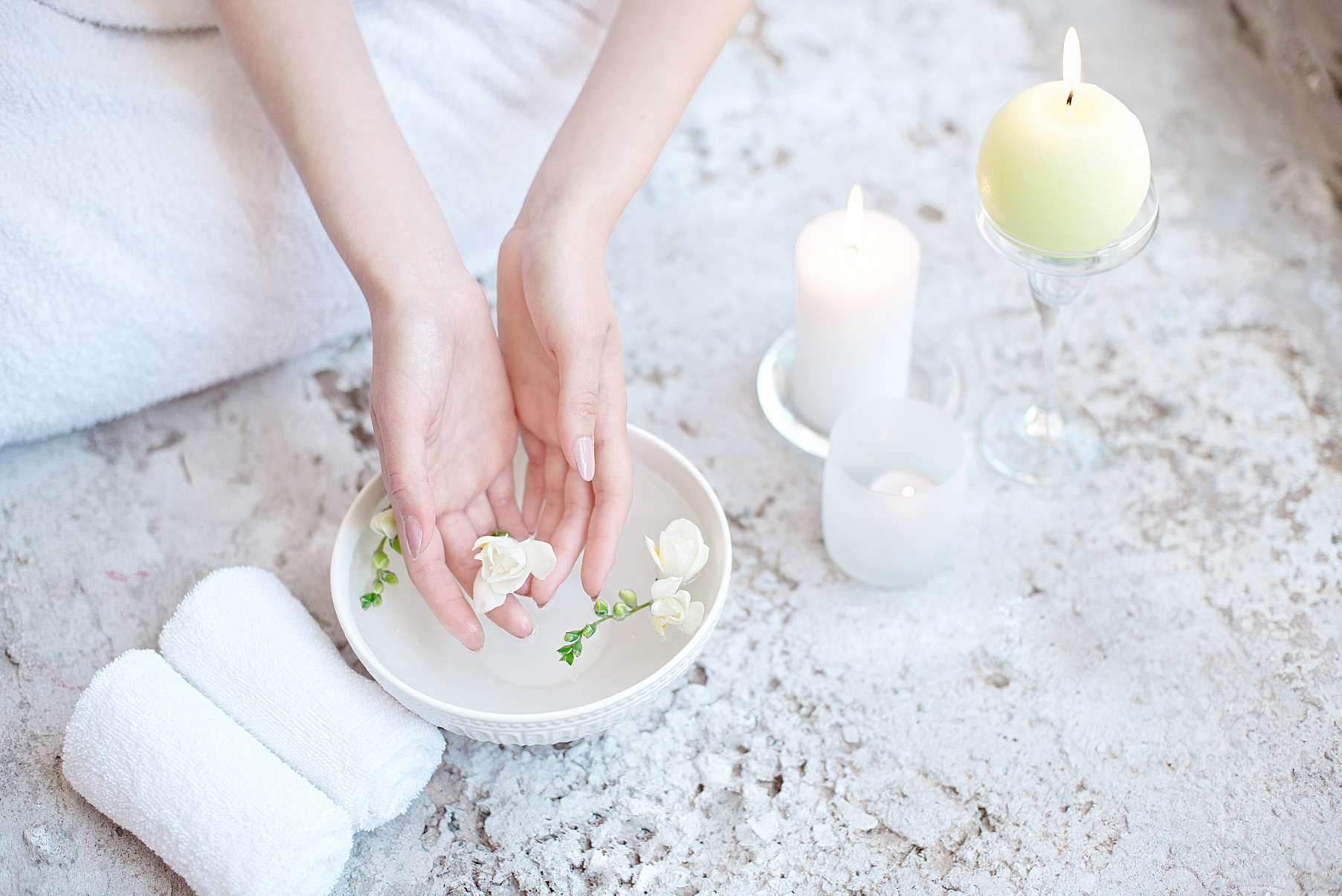 Woman In Beauty Salon Holding Hands In Aroma Bath Before Spa Procedure